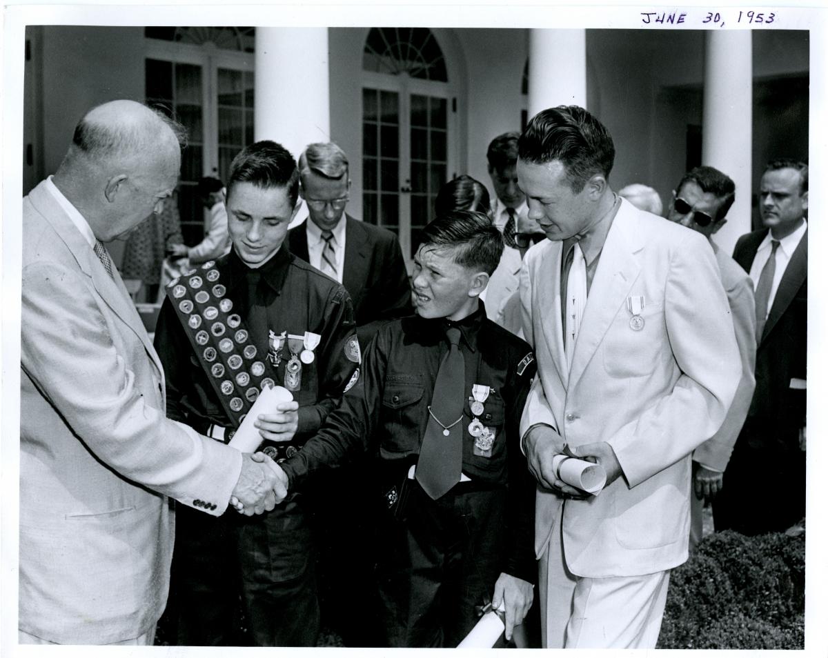 Dwight D. Eisenhower presents Young American Medals for Bravery and Service to three young boys in the White House Rose Garden. June 30, 1953 [72-362-2]