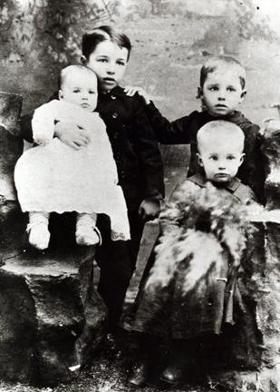 1893 - This is the first known photograph of DDE. Arthur is holding Roy and DDE is sitting in front of Edgar.