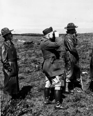 Colonel Eisenhower (center) looks through field glasses during the Louisiana Maneuvers, 1941 [64-57-4]