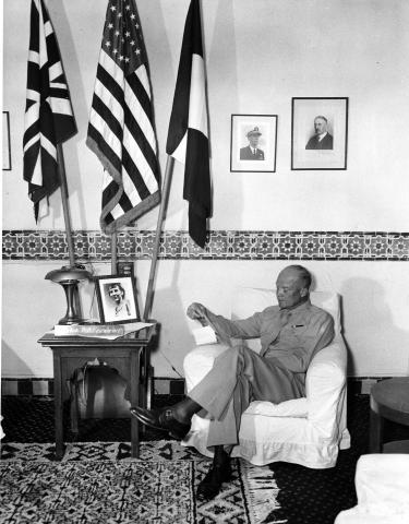 General Eisenhower reads a letter from Mrs. Eisenhower in his Army Headquarters at the Hotel St. George. Algiers, North Africa. 1943 [65-778-1]