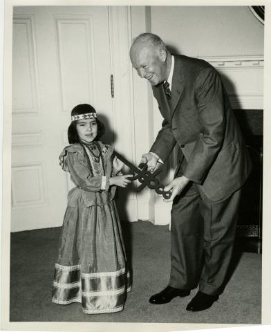 President Eisenhower received the Sword of Hope in connection with the opening of the 1957 Cancer Crusade.  Joyce Dezeller, a 6 year old Indian girl who is a cured cancer victim, presented the Cancer symbol to the President. March 29, 1957 [72-2159-1]