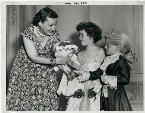 Mamie D. Eisenhower greets two children in costume representing the Children of the Revolution. April 25, 1953 [72-238-2]