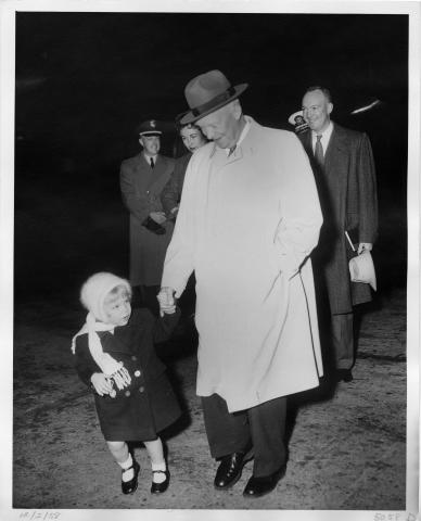 President Dwight D. Eisenhower and granddaughter Mary Jean Eisenhower leave Augusta, Georgia, for a flight back to Washington, DC, following a vacation. December 2, 1958. 72-2912-2.