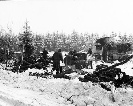 Ardennes-Battle of the Bulge. January 25, 1945 - The 7th Armored Division make ready to move up after having given artillery support to the infantry in their battle for high ground near St. Vith, Belgium. Snow covers the ground.