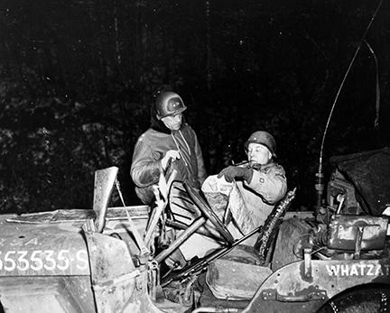 Ardennes-Battle of the Bulge. January 1, 1945 - Major General Maurice Rose (left) confers with Brigadier General Doyle O. Hickey as the column of armor which they are leading is temporarily held up by enemy artillery fire on the outskirts of Floret, Belgium.