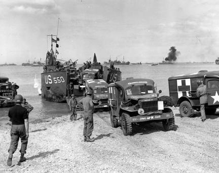 July 1, 1944 - This Rhino ferry unloads its cargo of Army ambulances on a beach in France, to provide equipment for more front line hospitals