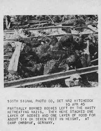 April 10, 1945 - Partially burned bodies left by retreating Nazis at Ohrdruf concentration camp. The bodies were stacked one layer of bodies and one layer of wood for about six or seven feet in height.