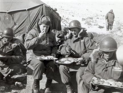 December 4, 1952 - Dwight D. Eisenhower and Sgt. Virgil Hutcherson, Squad Leader, Co. "B", 15th Infantry Regiment, 3rd US Infantry Division, eat dinner in Korea [77-18-898]