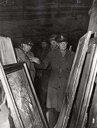 April 12, 1945 - General Dwight D. - Eisenhower inspects art treasures looted by the - Germans and stored in the depths of a salt mine in Germany along with gold, - silver, and paper currency. The mine was captured by U.S. Third Army troops. Behind - DDE are (left) General Omar Bradley and - (right) Lt. General George S. Patton