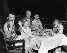 President Dwight D. Eisenhower and Mrs. Mamie Eisenhower spend a weekend vacation at Camp David with their grandchildren. Left to right: Mamie Eisenhower holding Susan, Dwight D. Eisenhower, David, and Anne. July 30-31, 1954. 67-82-A-19.