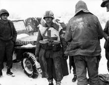 Ardennes-Battle of the Bulge. January 24, 1945 - A German medic carried his supplies in the two U.S. field glass cases hung on his belt when captured by the 1st Army at Butgenbach, Belgium. Snow covers the ground.
