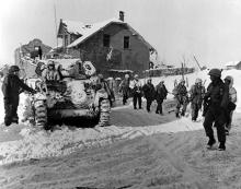 Ardennes-Battle of the Bulge. January 24, 1945 - Parachute infantry move on snow covered ground toward the front to keep up the pressure being applied to the Germans beyond St. Vith, Belgium.