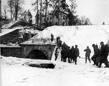 Ardennes-Battle of the Bulge. January 17, 1945 - The 75th Infantry Division troops cross bridge leading to the town of Vielsalm, Belgium.