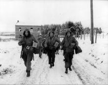 Ardennes-Battle of the Bulge. January 11, 1945 - Pfc M.L. Dickens, East Omaha, Nebraska, Pvt Sunny Sundquist, Bremerton, Washington, Sgt Francis H. McCann, Middleton, Conn., of the 101st Airborne Division near Bastogne, Belgium, set out to rejoin their unit.
