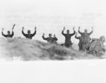 June 9, 1944 - Germans, former "Herrenvolk", surrender and are rounded up by American soldiers, one of which can be seen at extreme right