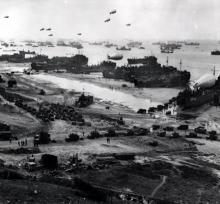 Panoramic view of supplies being brought ashore for Allied invaders