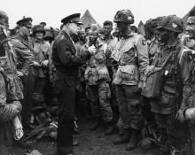 June 5, 1944 - Dwight D. Eisenhower speaks with paratroopers of the 101st Airborne Division just before they board their planes to participate in the first assault of the Normandy invasion [77-18-112]