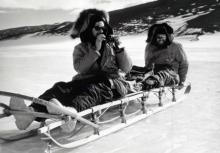Antarctica - Chilean geologist Fernando Hunizaga and Texas Technological College geologist Charles King on a sled in the Shackleton Glacier Area. They are members of a party making a study of the terrain in the area of the Roberts Massif.