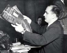 Senator Joseph R. McCarthy holding a photostat of the "Daily Worker" which includes an advertisement for a Communist front organization to which he alleged that Miss Dorothy Kenyon, a former State Department employee, had once joined.